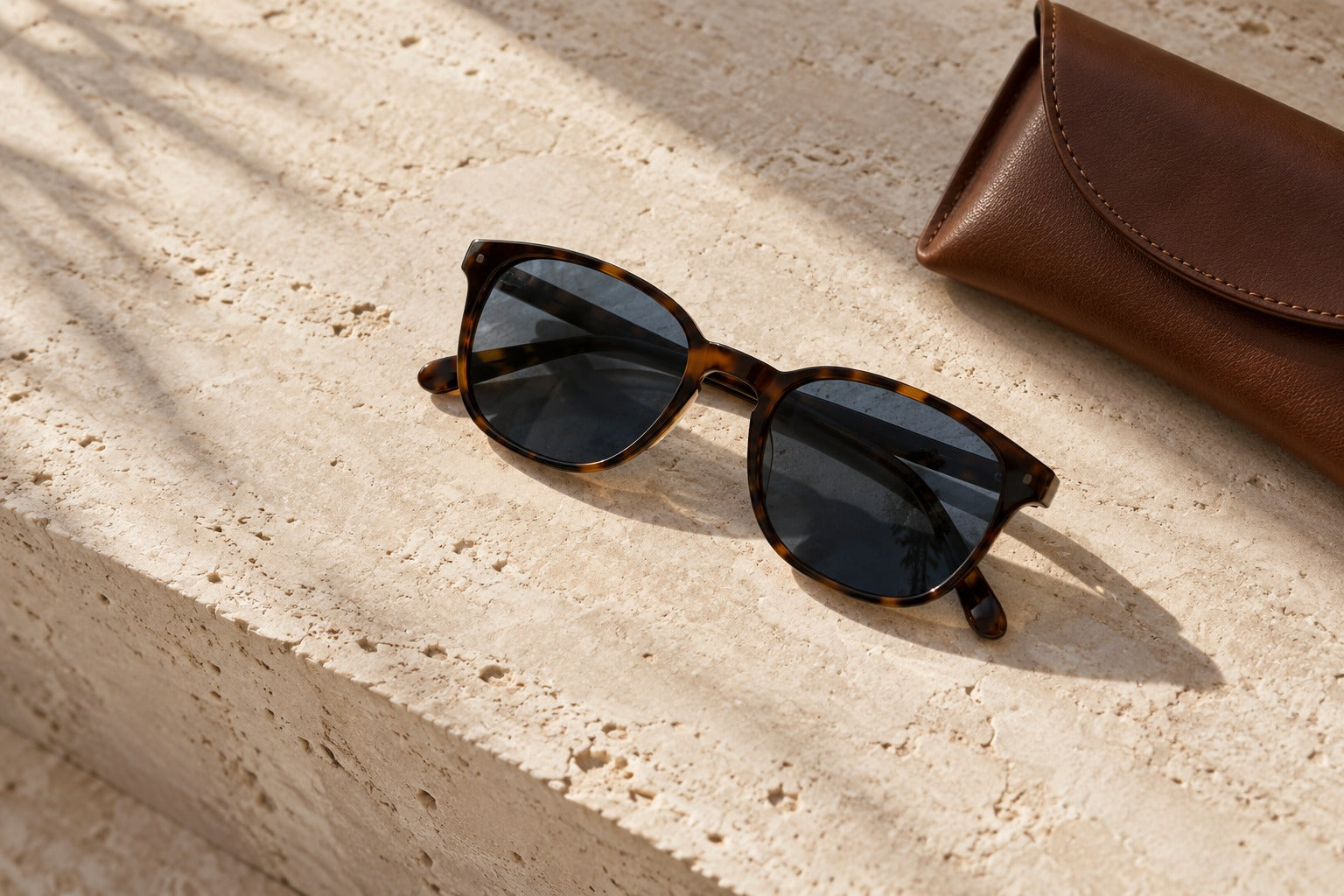 Unbranded sunglasses and leather in soft architectural light